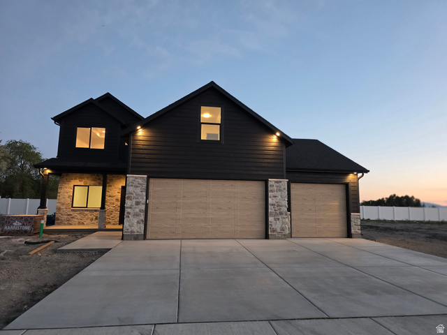 1267 West 2350 South Perry, UT 84302 - Photo 5 of 35 Modern two-story residence featuring dark siding and stone veneer accents