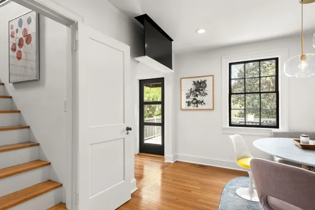 a living room with furniture and painting on the wall