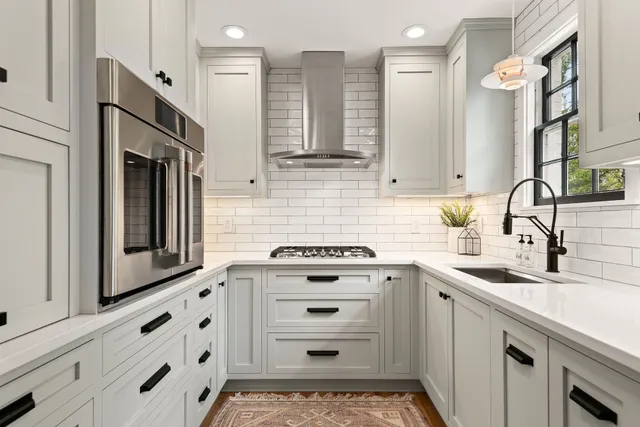 a kitchen with cabinets appliances and a sink