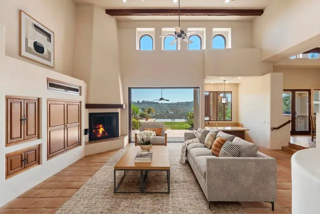 a view of an entryway with a fireplace and a floor to ceiling window