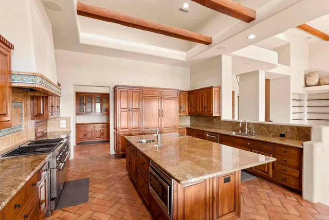 a kitchen with a stove a sink and a refrigerator