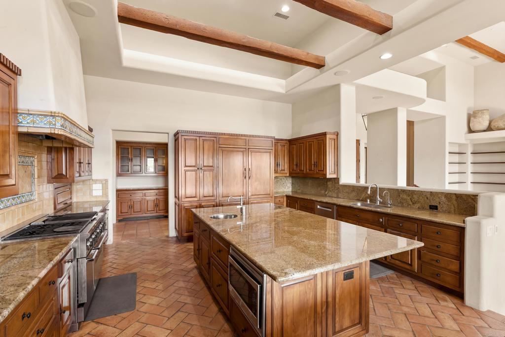 3435 Jasmine Crest Encinitas, CA 92024 - Photo 24 of 41 a kitchen with granite countertop a sink stove and cabinets