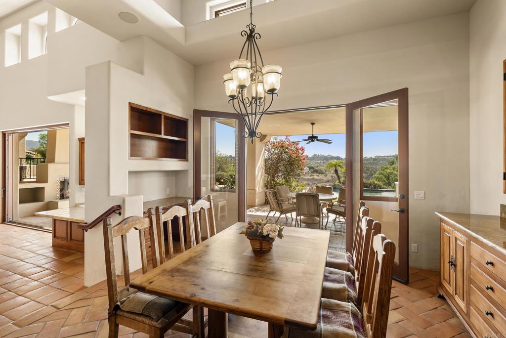 3435 Jasmine Crest Encinitas, CA 92024 - Photo 26 of 41 a view of a dining room with furniture large windows and wooden floor