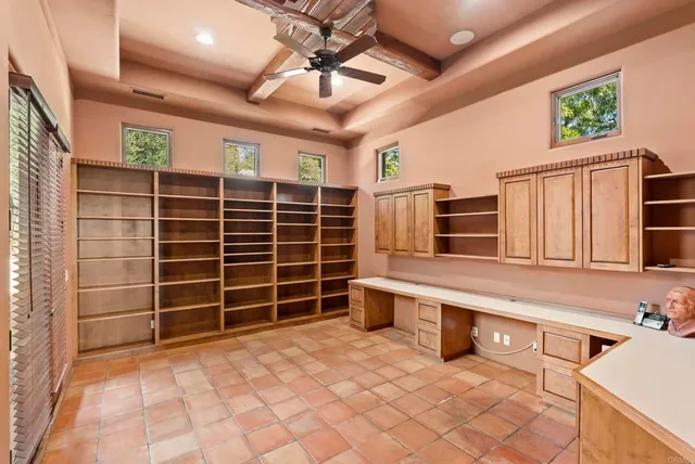 a bedroom with a large bed a flat tv screen and a fireplace