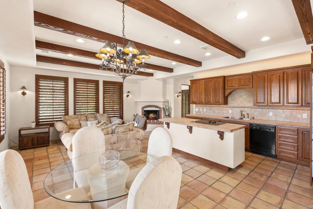 3435 Jasmine Crest Encinitas, CA 92024 - Photo 40 of 41 a living room with furniture a chandelier and kitchen view
