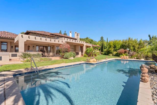 a view of a balcony with floor to ceiling windows and wooden fence
