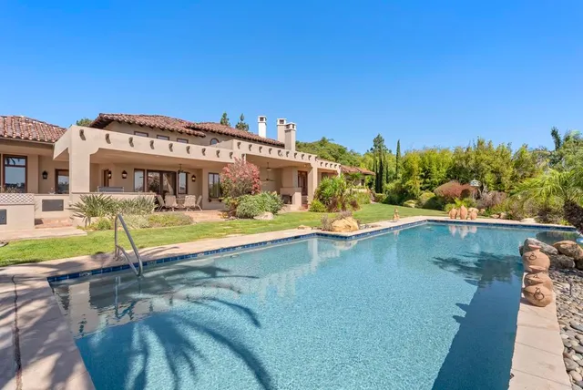 a view of a balcony with floor to ceiling windows and wooden fence