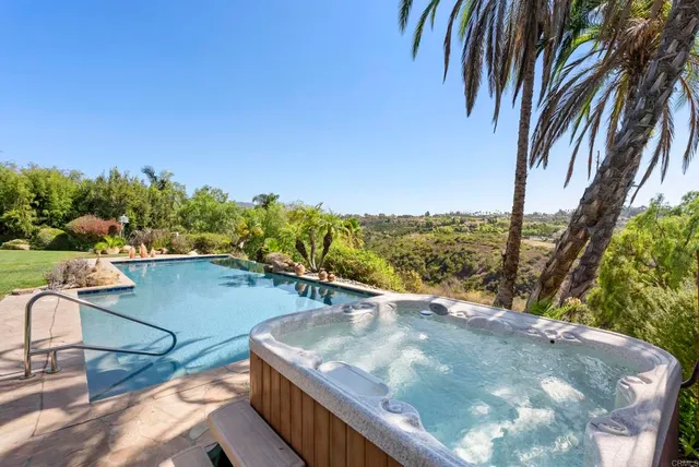 a view of an house with swimming pool and sitting area