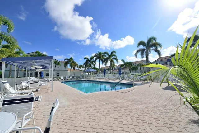 a view of swimming pool with outdoor seating and outdoor seating
