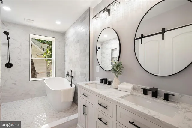 a bathroom with a toilet a sink a mirror and a bathtub