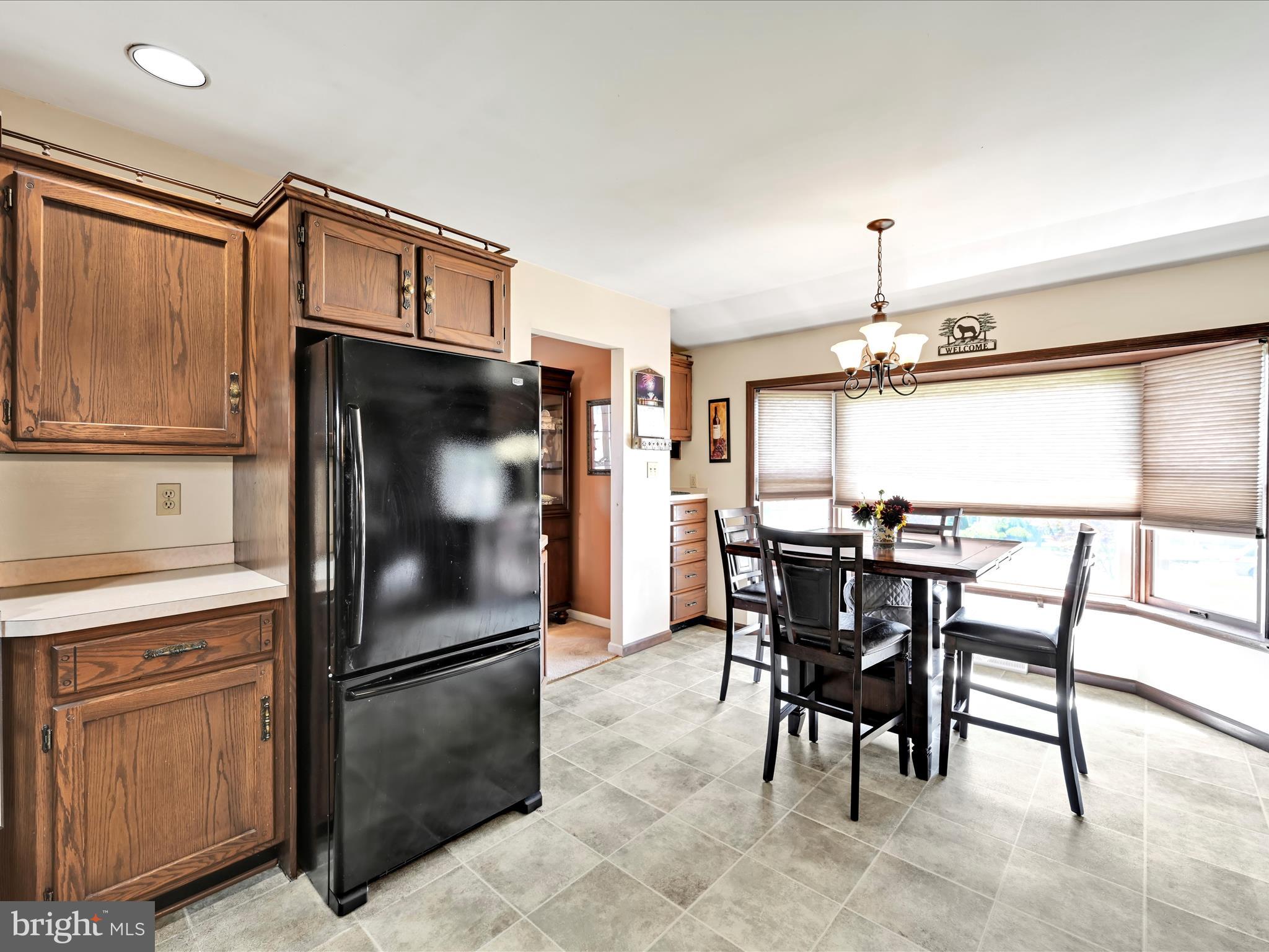 600 Beech Street Reading, PA 19605 - Photo 13 of 50 a kitchen with a refrigerator a table and chairs