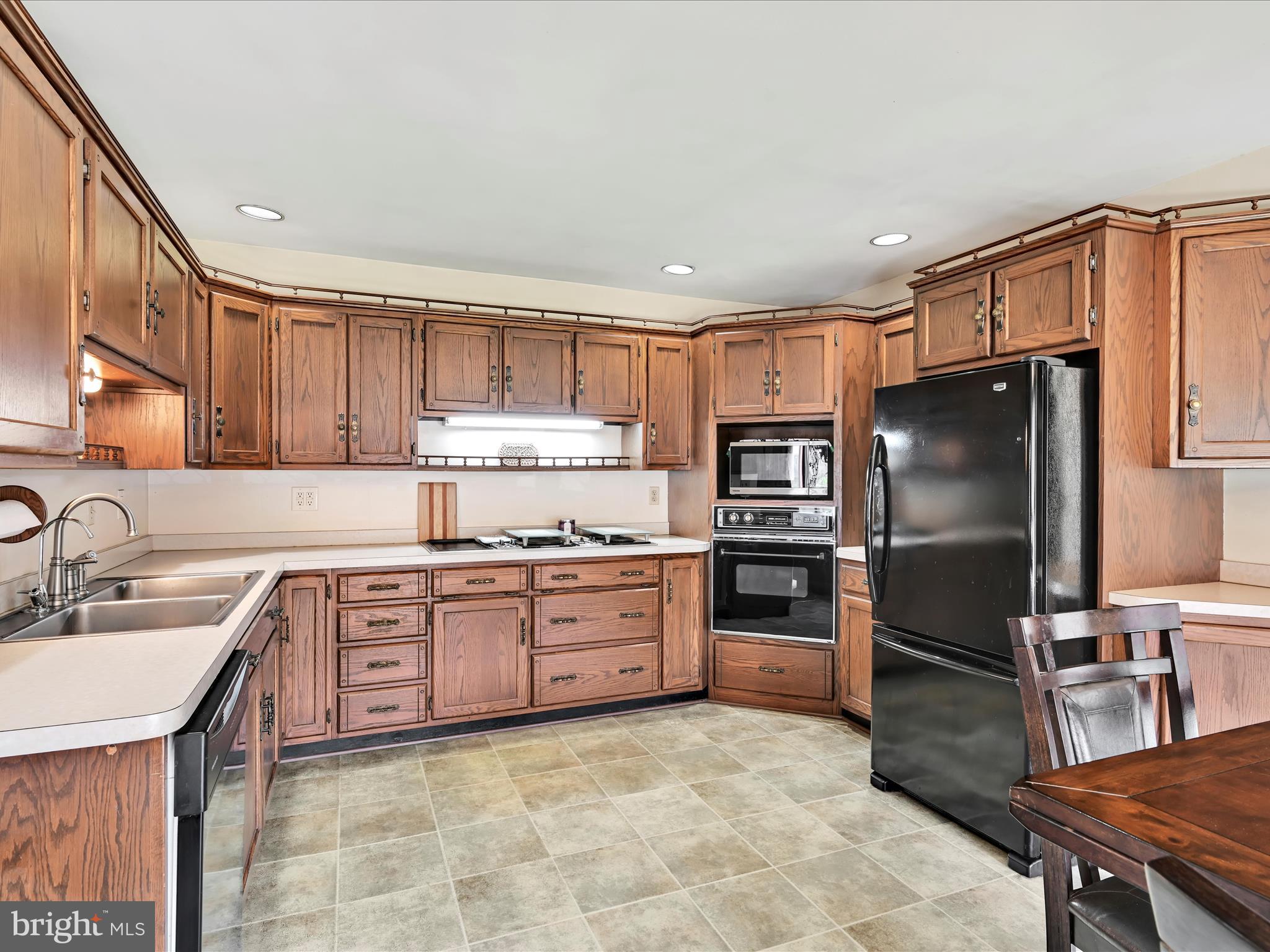 600 Beech Street Reading, PA 19605 - Photo 14 of 50 a kitchen with stainless steel appliances granite countertop a refrigerator stove top oven and sink