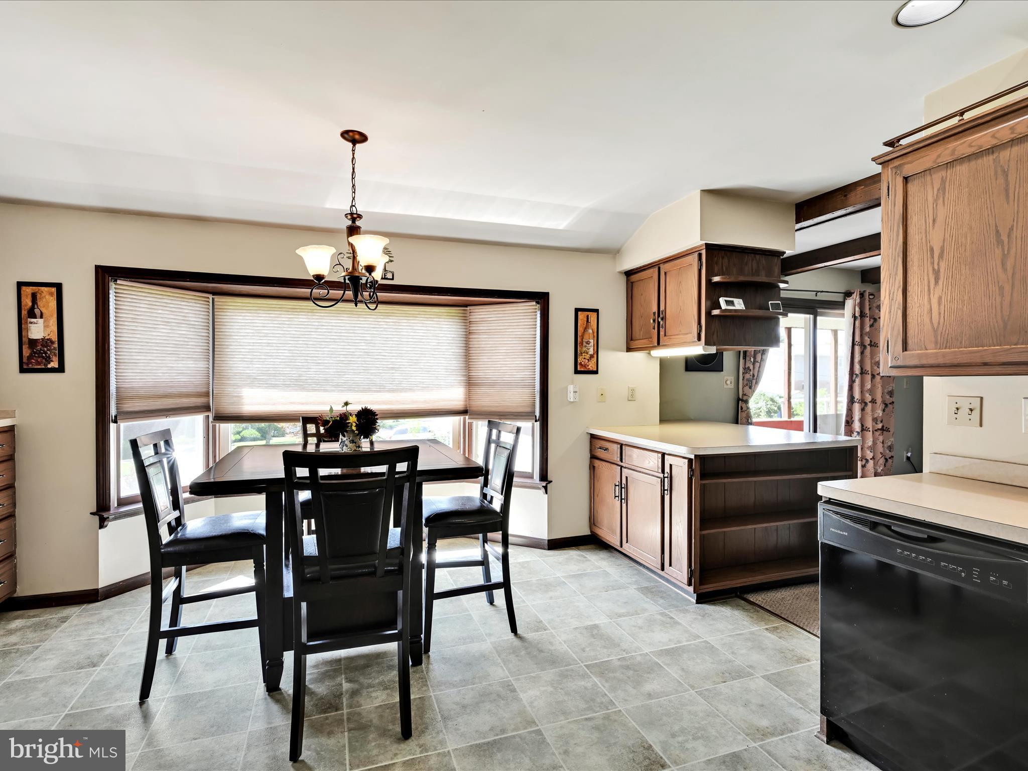 600 Beech Street Reading, PA 19605 - Photo 16 of 50 a kitchen with a table chairs stove and refrigerator