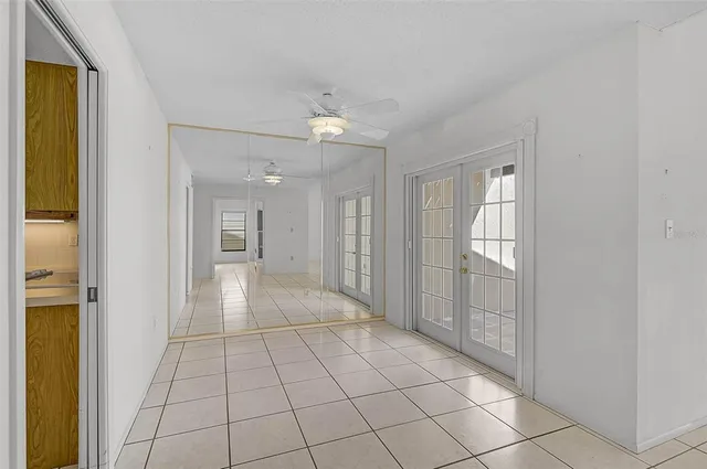 a view of an empty room with window and cabinet