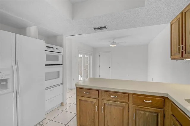 a view of cabinets and a refrigerator in a kitchen