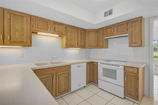 a kitchen with a sink stove and cabinets