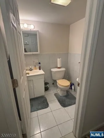 a bathroom with a sink toilet and mirror