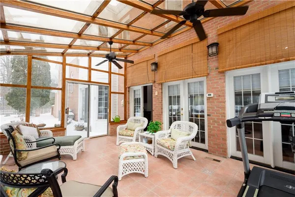 a living room with furniture and floor to ceiling windows