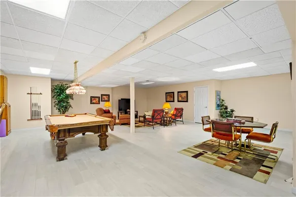 a living room with furniture gym equipment and a table