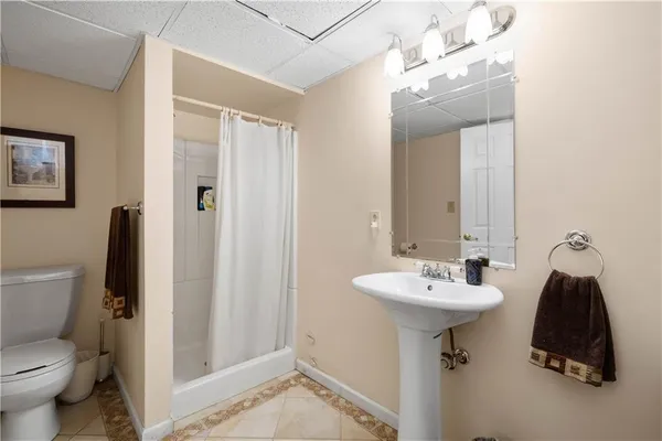 a bathroom with a sink toilet and mirror