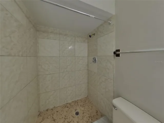 a bathroom with a shower a toilet and a sink