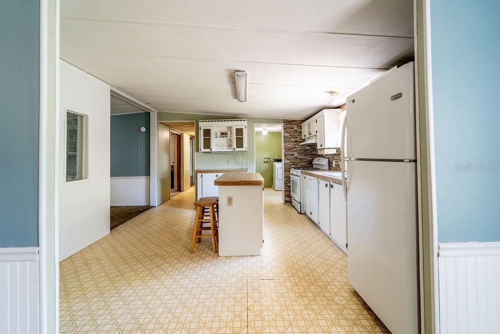 24031 Armadillo Road Astor, FL 32102 - Photo 18 of 43 a view of kitchen with furniture and refrigerator