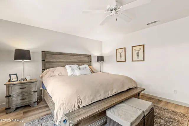 a bed sitting in a bedroom next to a window