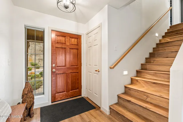 a view of entryway with wooden floor and front door