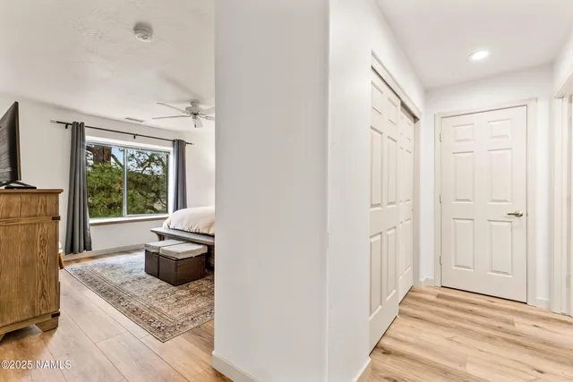 a bedroom with a large bed and a chandelier