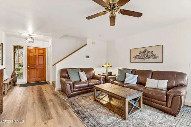 a living room with furniture and a ceiling fan