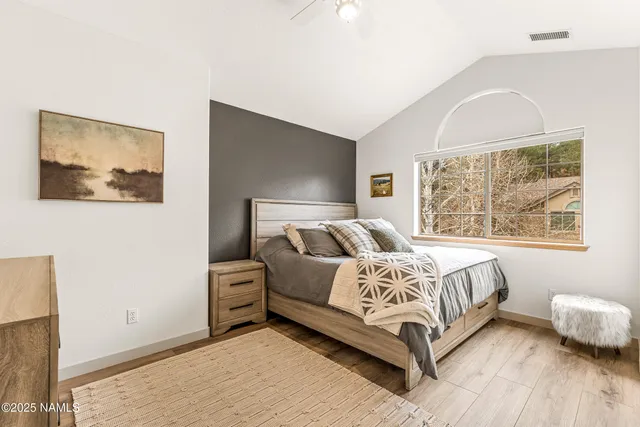 a bed sitting in a bedroom next to a window