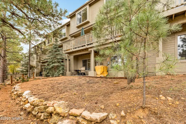 a view of a white house with a yard