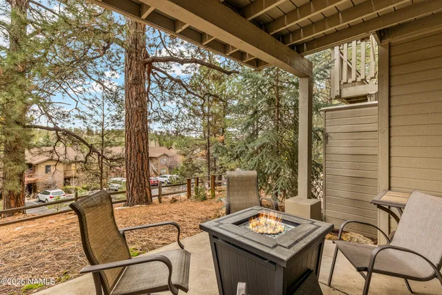 a view of a chairs and table in the balcony