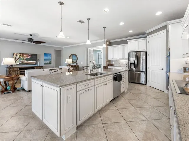 a living room with furniture and a ceiling fan