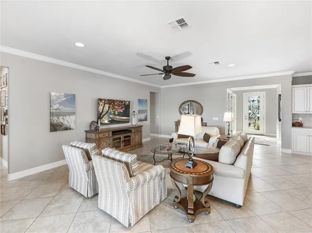 a dining room with wooden floor a chandelier a wooden table and chairs