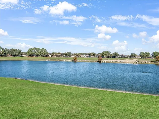 a view of a lake with houses in the background