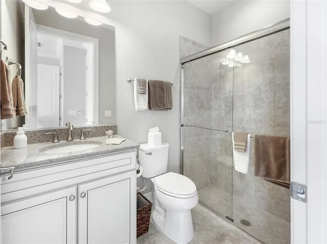 a kitchen with granite countertop white cabinets and stainless steel appliances
