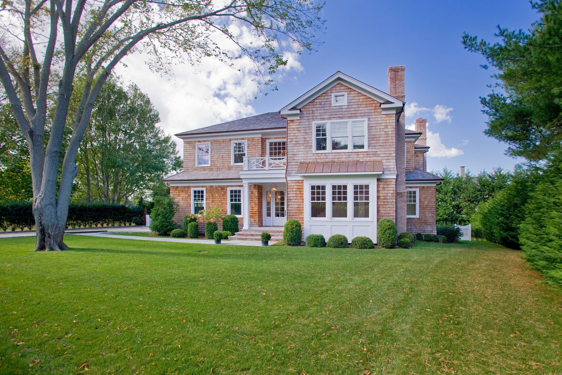 Undisclosed Address Water Mill, NY 11976 - Photo 2 of 16 a front view of a house with a yard