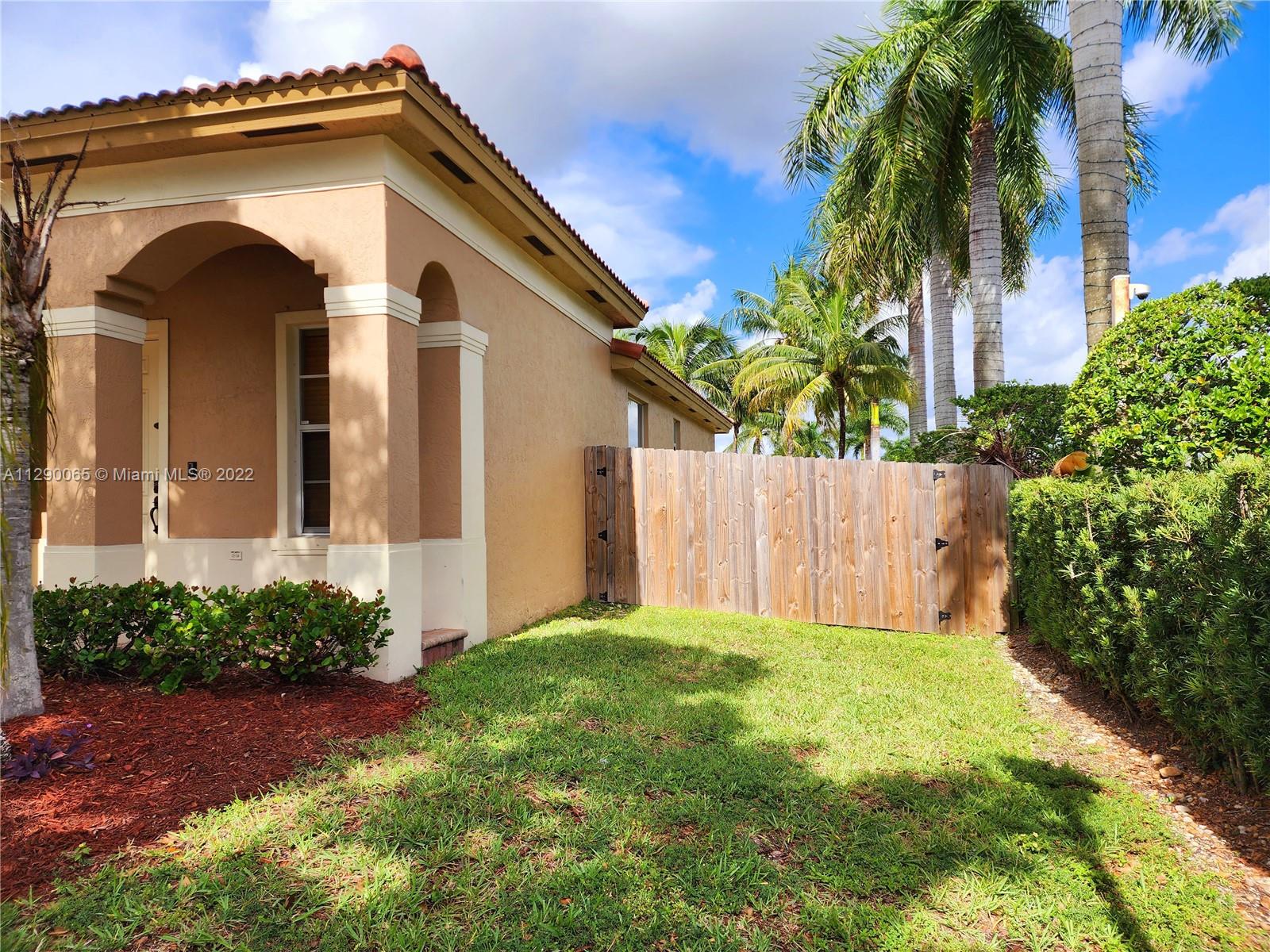 2134 Northeast 38th Road Homestead, FL 33033 - Photo 2 of 16 a front view of a house with a yard