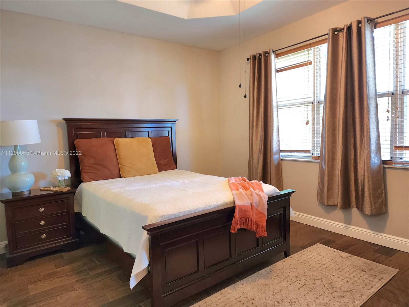 2134 Northeast 38th Road Homestead, FL 33033 - Photo 8 of 16 a bedroom with a bed and wooden floor