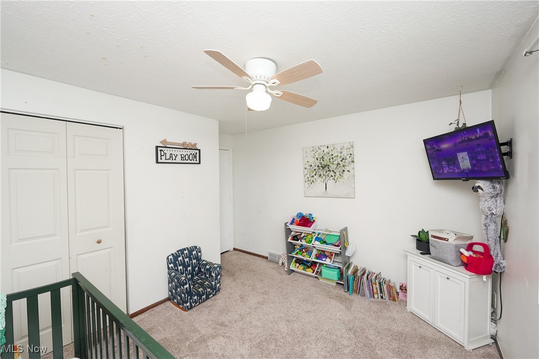 4099 Beach Road Medina, OH 44256 - Photo 35 of 46 1st floor bedroom featuring ceiling fan and light carpet