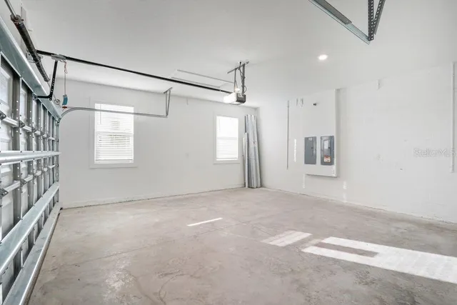 an empty room with windows and entrance