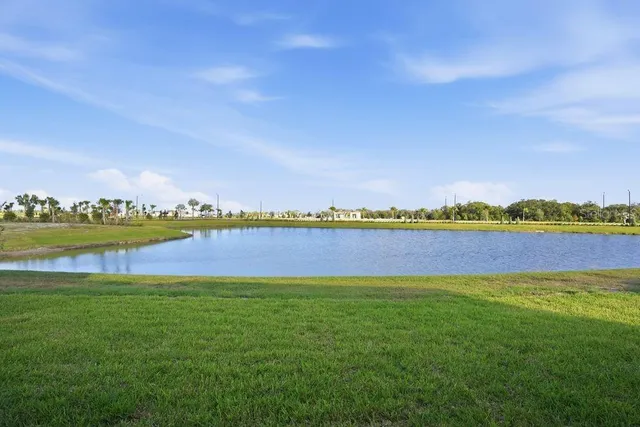 a view of a lake with houses in the back