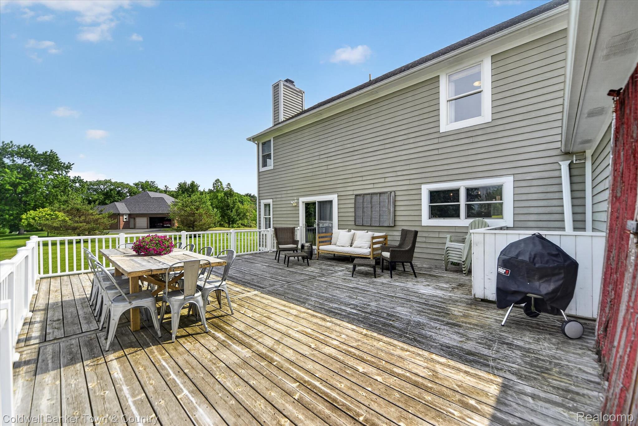 918 Gray Fox Court Howell, MI 48843 - Photo 62 of 84 Expansive rear deck featuring wood planking and white railing