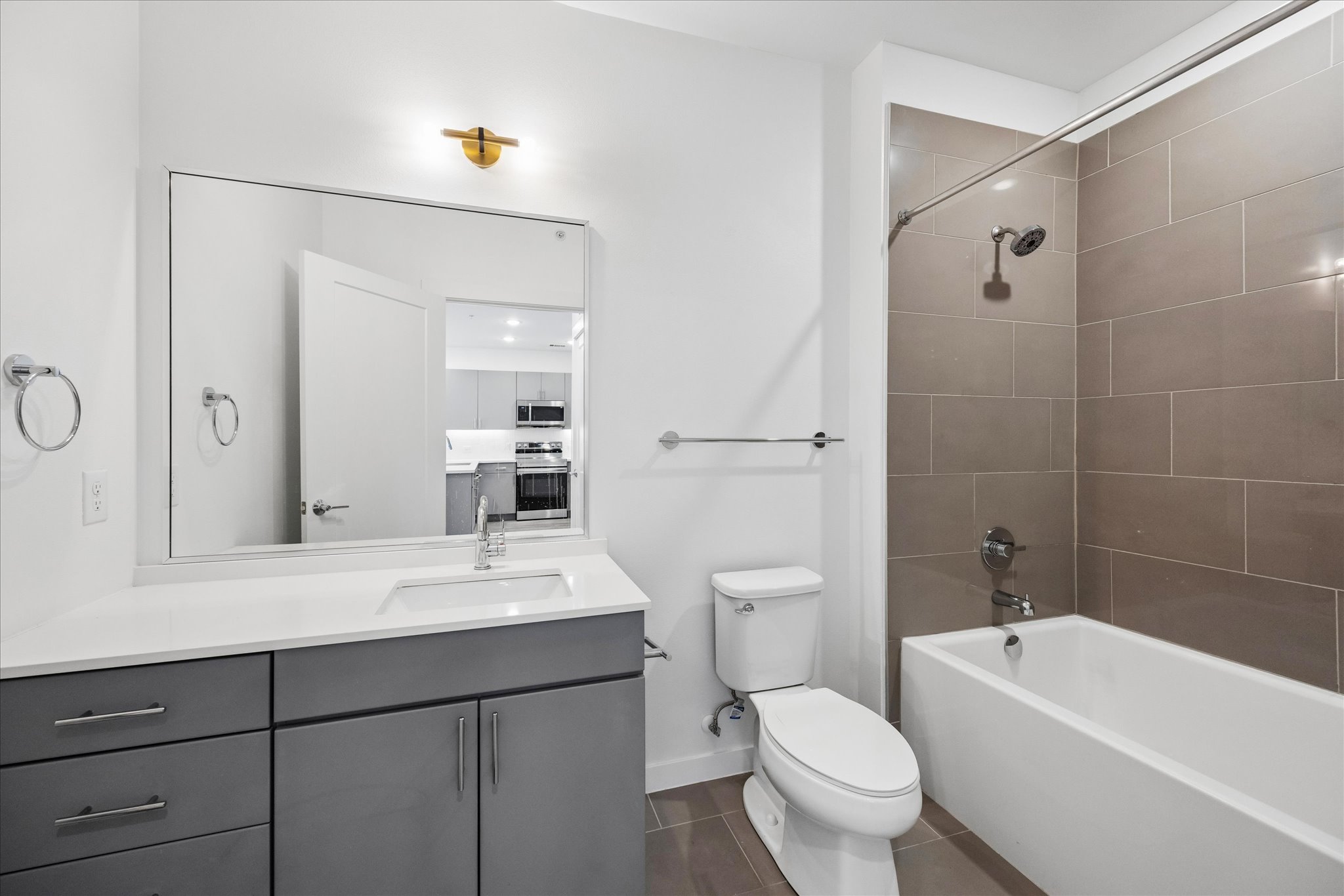 4801 Springdale Road, Unit 2210 Austin, TX 78723 - Photo 8 of 13 a bathroom with a toilet a sink a mirror and a bathtub