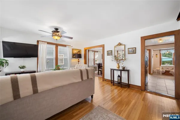 a kitchen with stainless steel appliances granite countertop a refrigerator a stove and a sink with couches