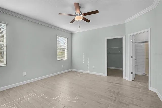 a view of an empty room with a ceiling fan