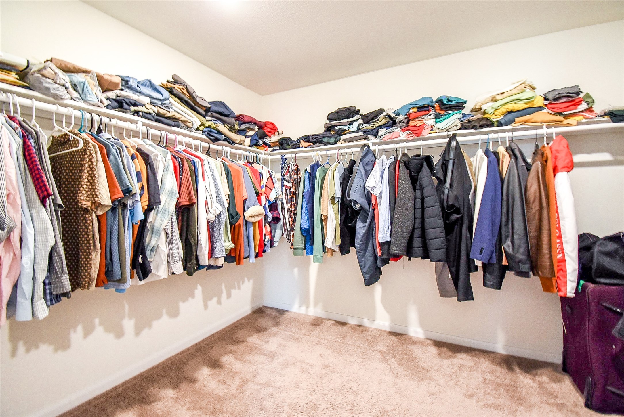 5912 Whitewing Road Rosenberg, TX 77469 - Photo 18 of 25 a view of walk in closet with clothes