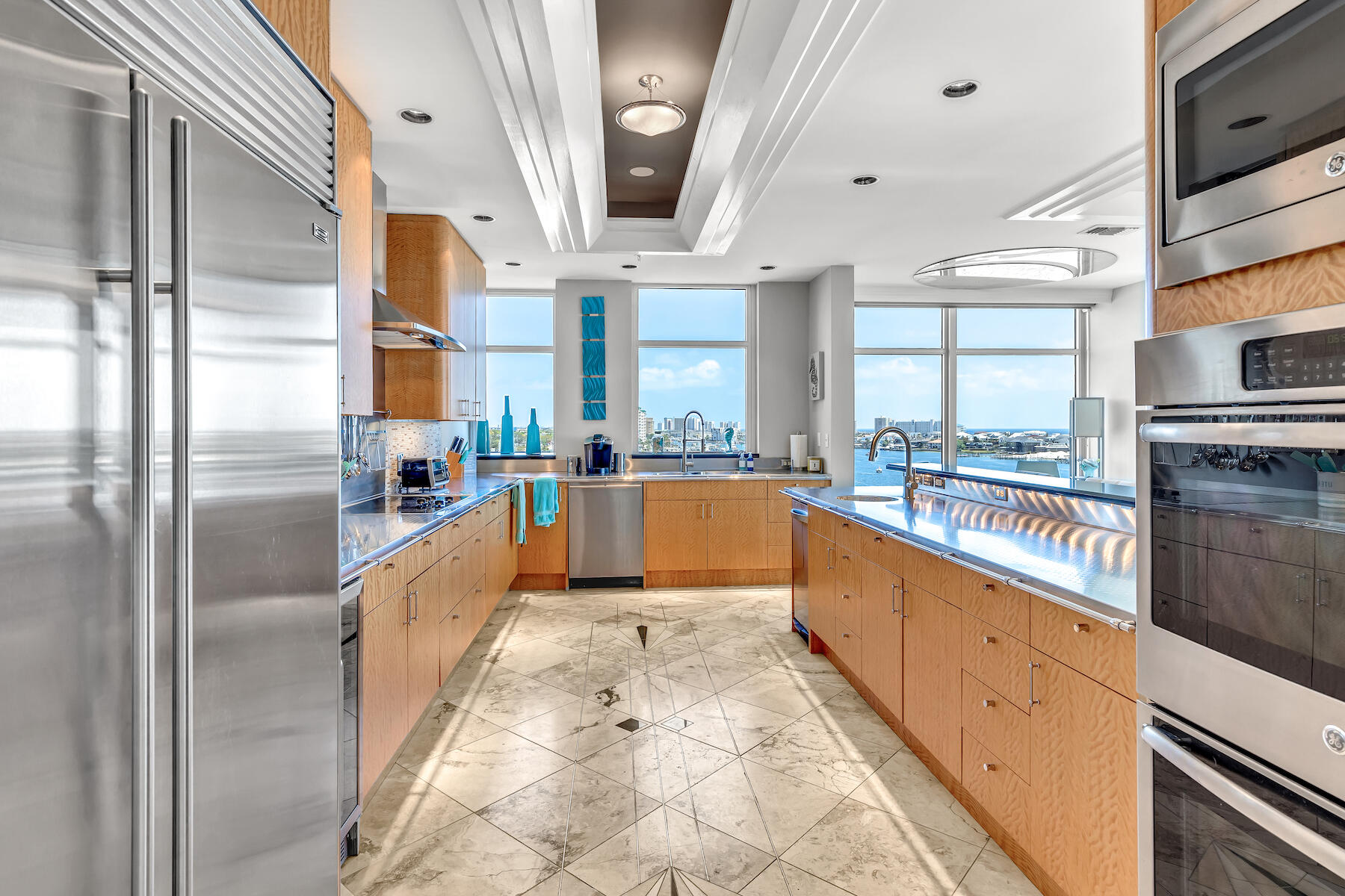 508 Harbor Boulevard, Unit 501 Destin, FL 32541 - Photo 13 of 47 a large kitchen with stainless steel appliances kitchen island granite countertop a large counter top stainless steel appliances and a window