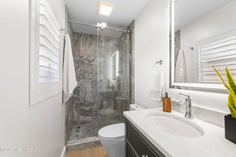 a bathroom with a sink toilet and shower